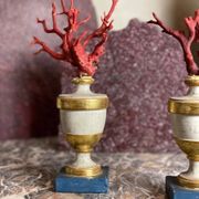 Pair of red corals on gilded and blue wooden bases