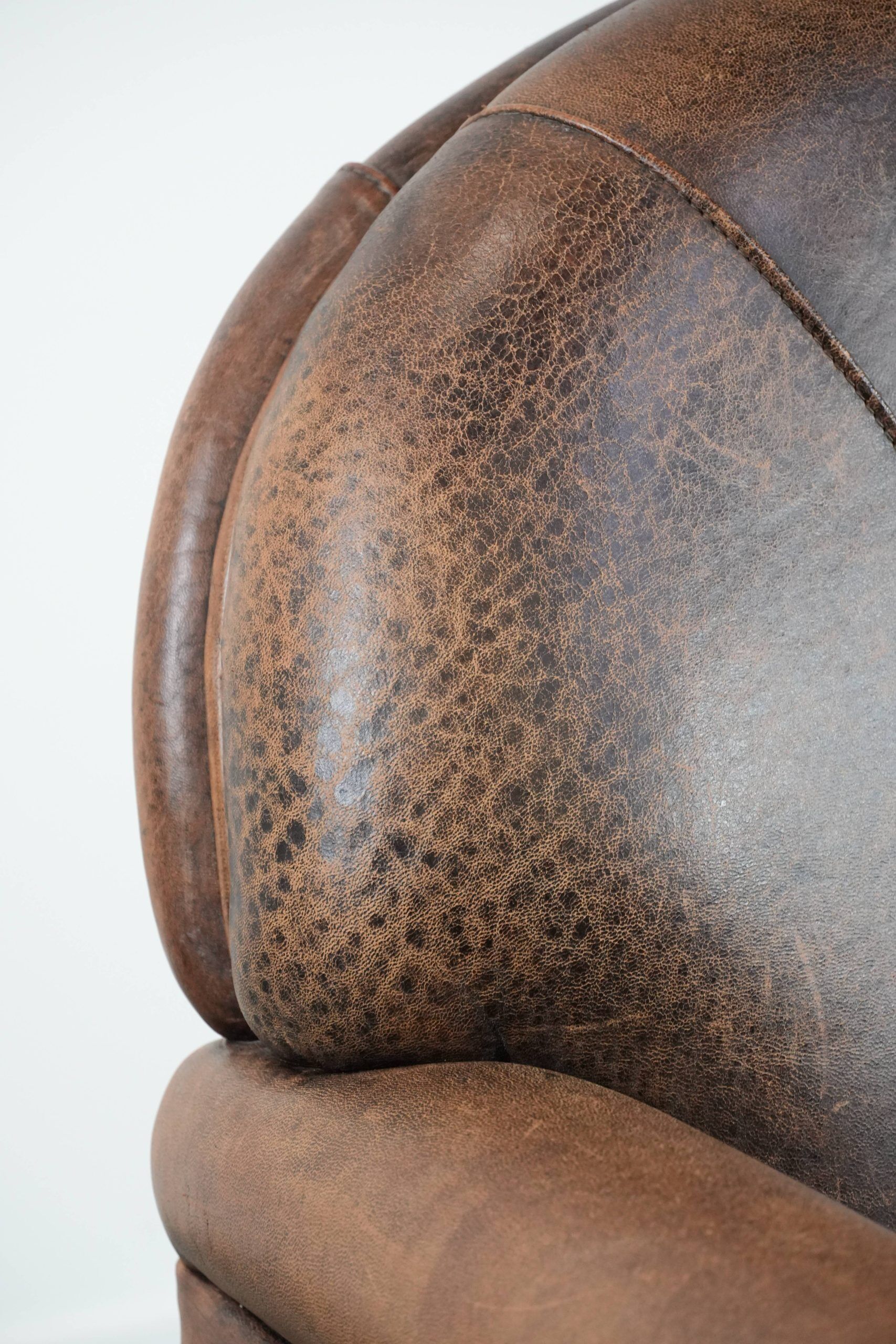 Vintage sheepskin armchair with warm colours and a characterful appearance