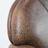 Vintage sheepskin armchair with warm colours and a characterful appearance