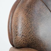 Vintage sheepskin armchair with warm colours and a characterful appearance