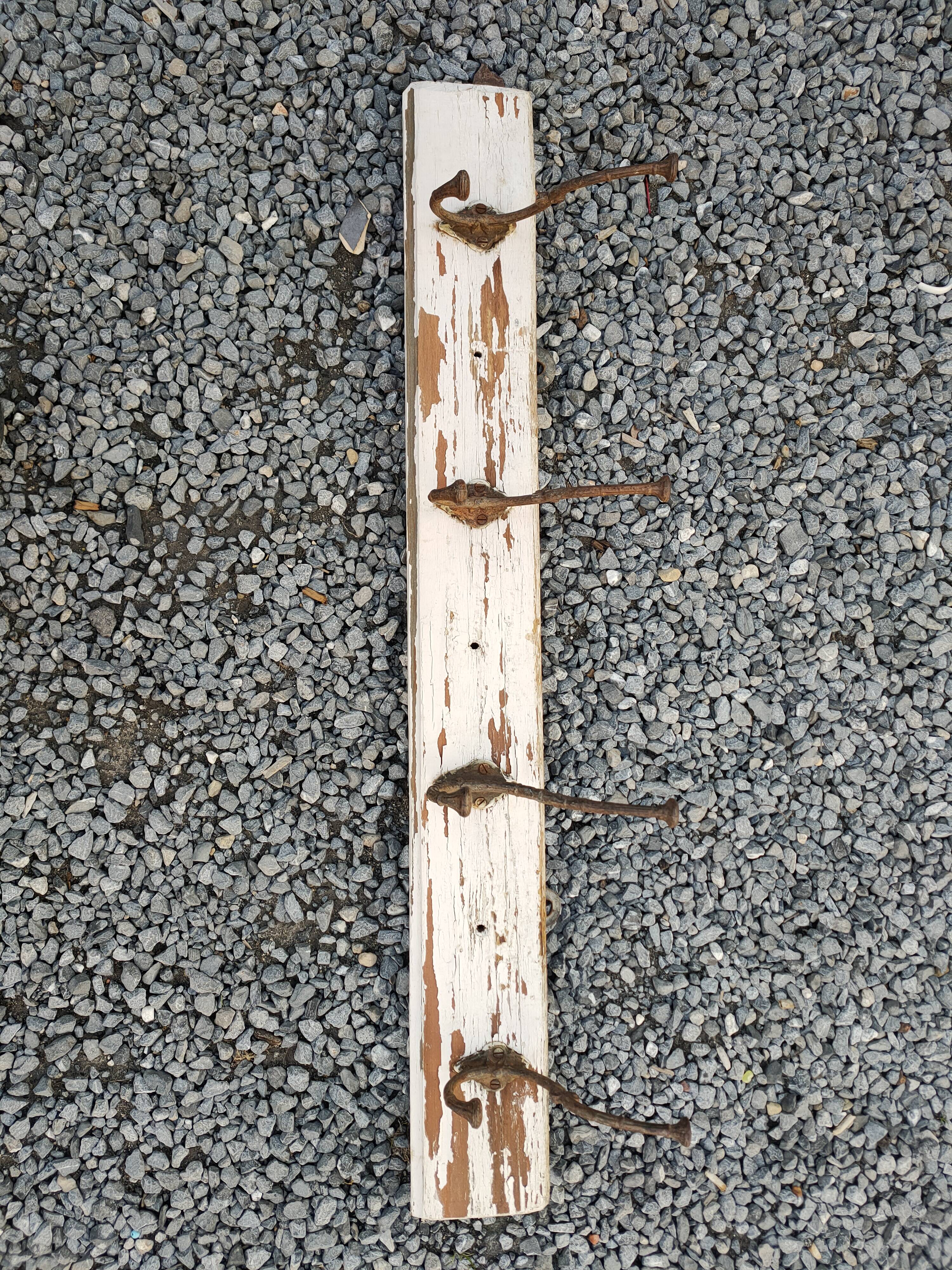 antique coat rack with 4 cast iron hooks