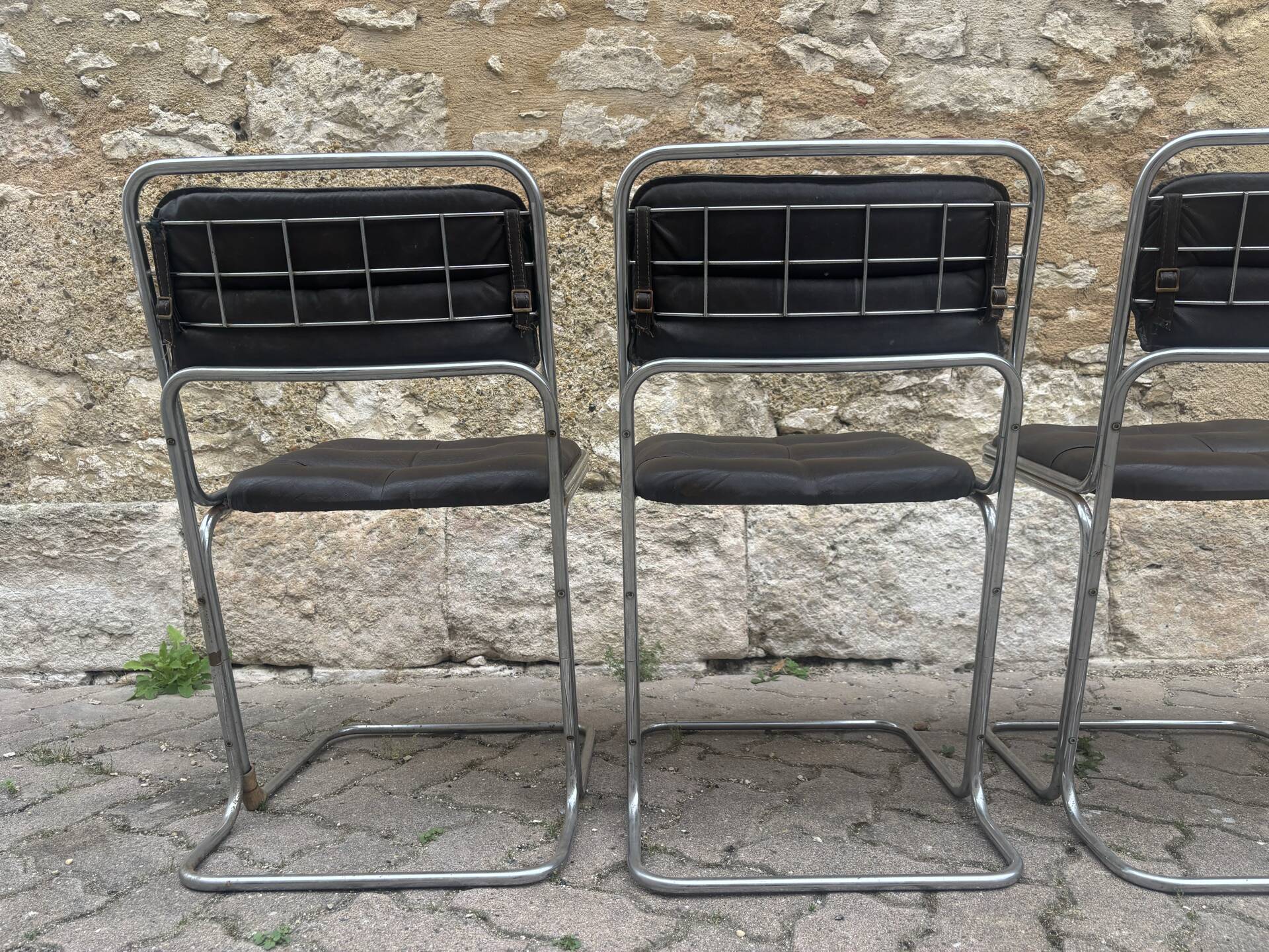 Four vintage chairs from the 1960s and 1970s, chrome with faux leather.