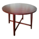 Round wooden table with thin legs