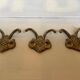 Three double brass coat hooks.