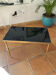 Table basse en laiton massif et plateau en verre noir