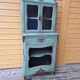 Blue patinated wooden display cabinet