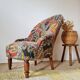 Small "madame" toad chair, vintage, upholstered in multicoloured floral fabric.