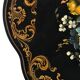 Blackened wooden side table decorated with a painted bouquet of flowers.