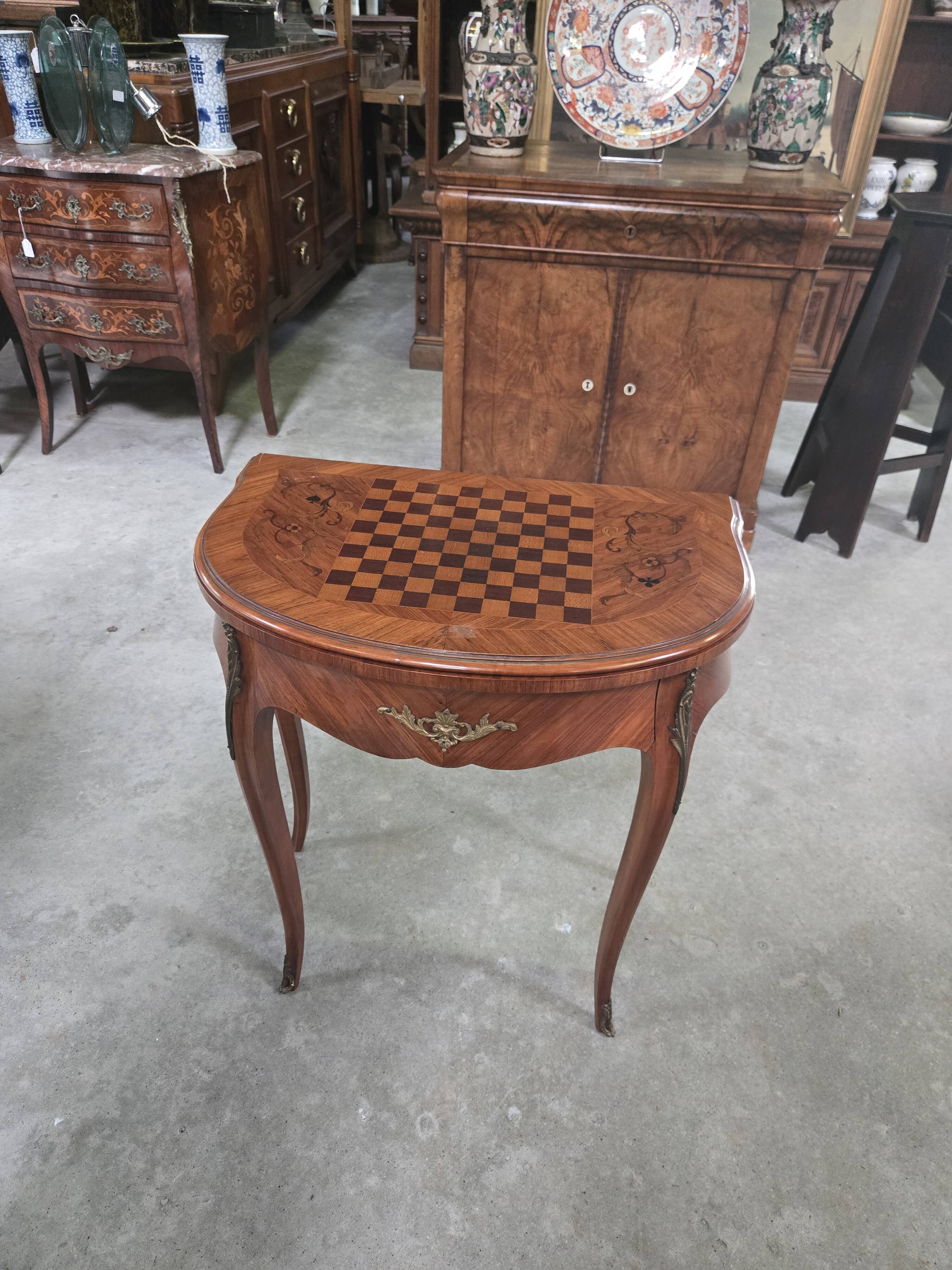 Half-moon gaming table in Louis XV style, made of precious wood marquetry.