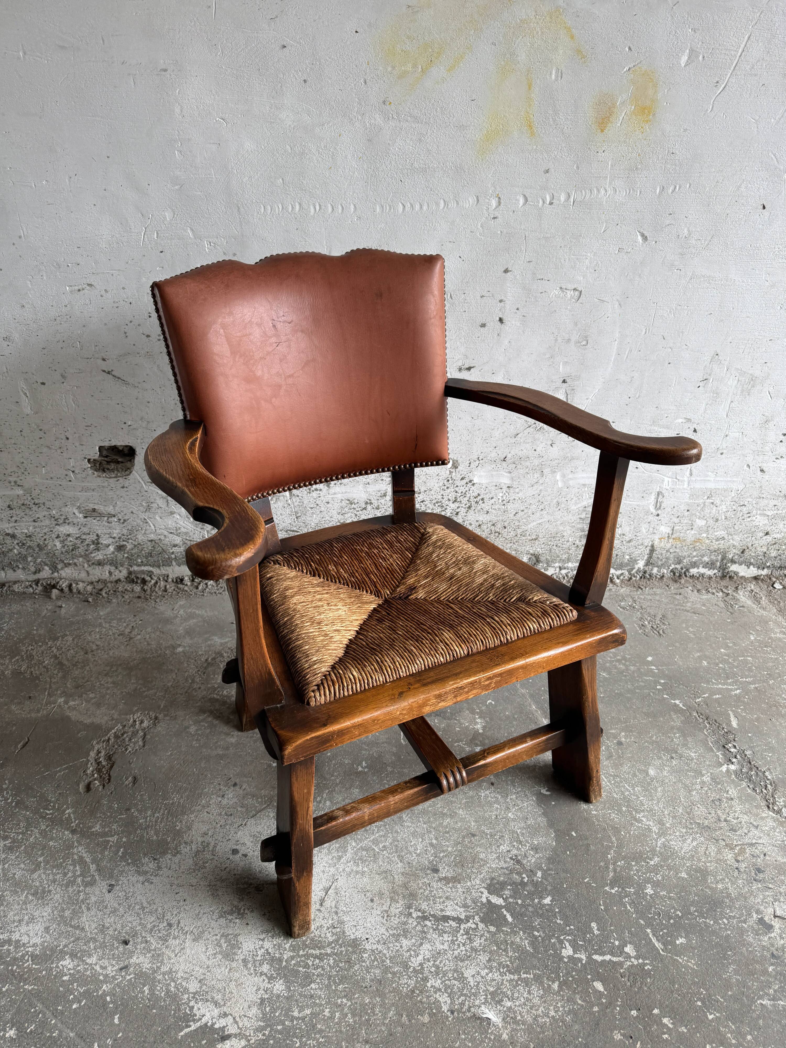 Brutalist dark brown solid wood armchair with natural rattan seat and cognac leather back