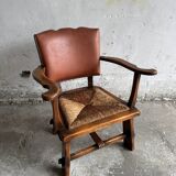 Brutalist dark brown solid wood armchair with natural rattan seat and cognac leather back