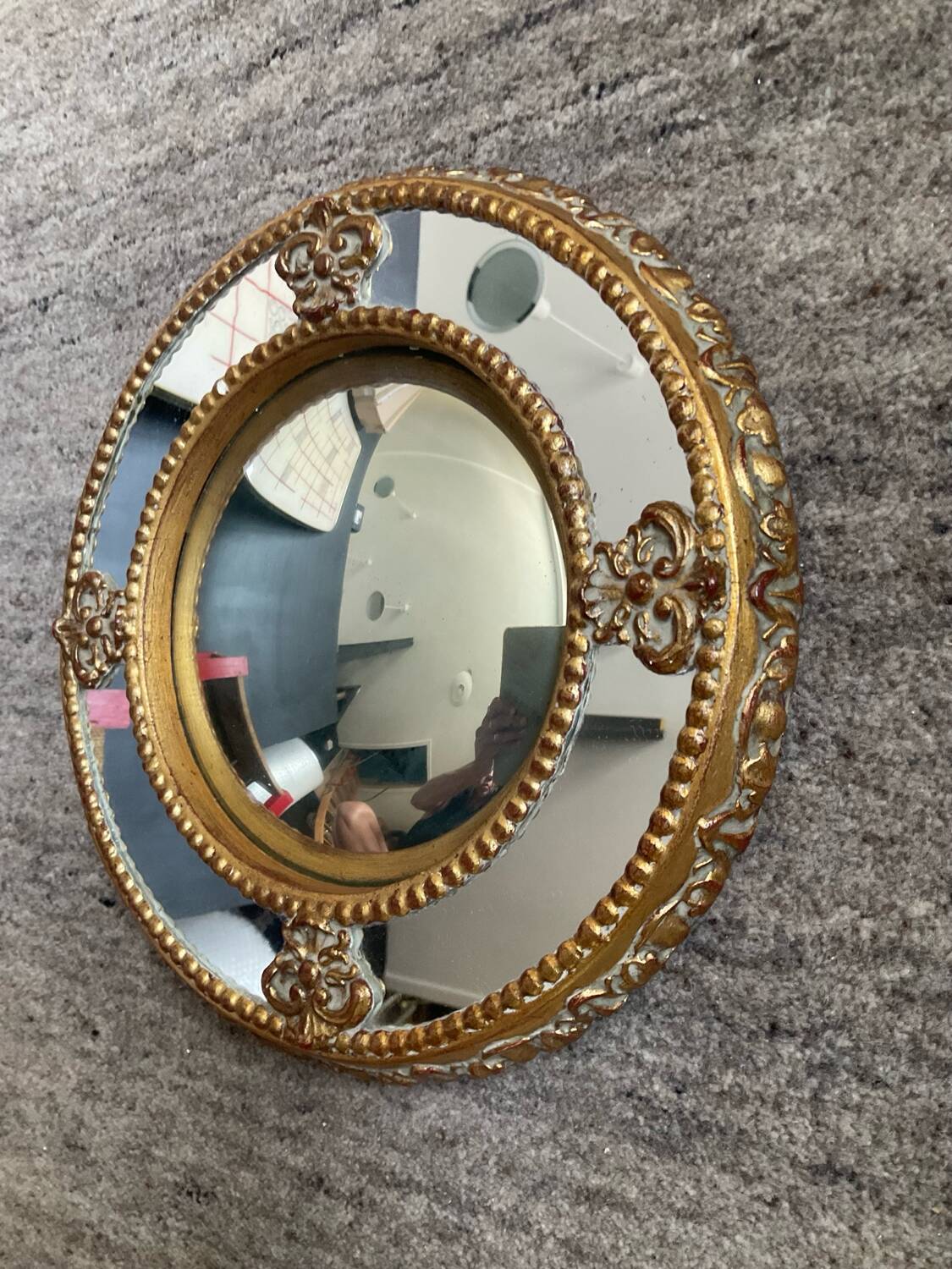 Antique domed witch's eye mirror in gilded wood