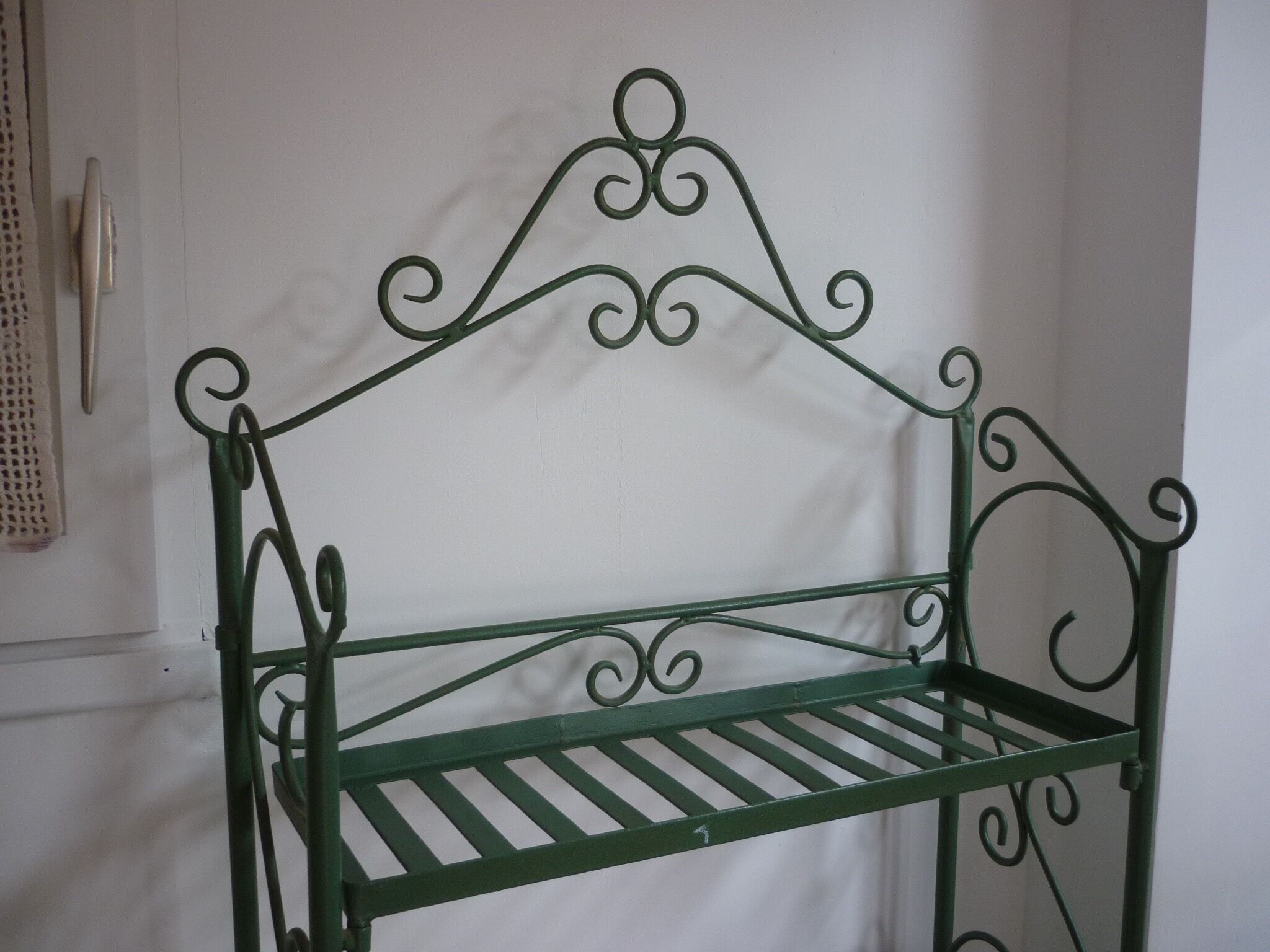 Folding green wrought iron shelf