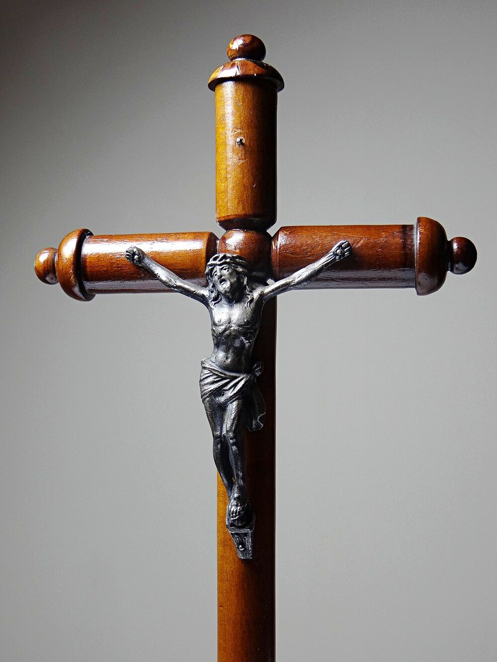 Antique wooden altar crucifix with a turned design and silver-plated Christ.