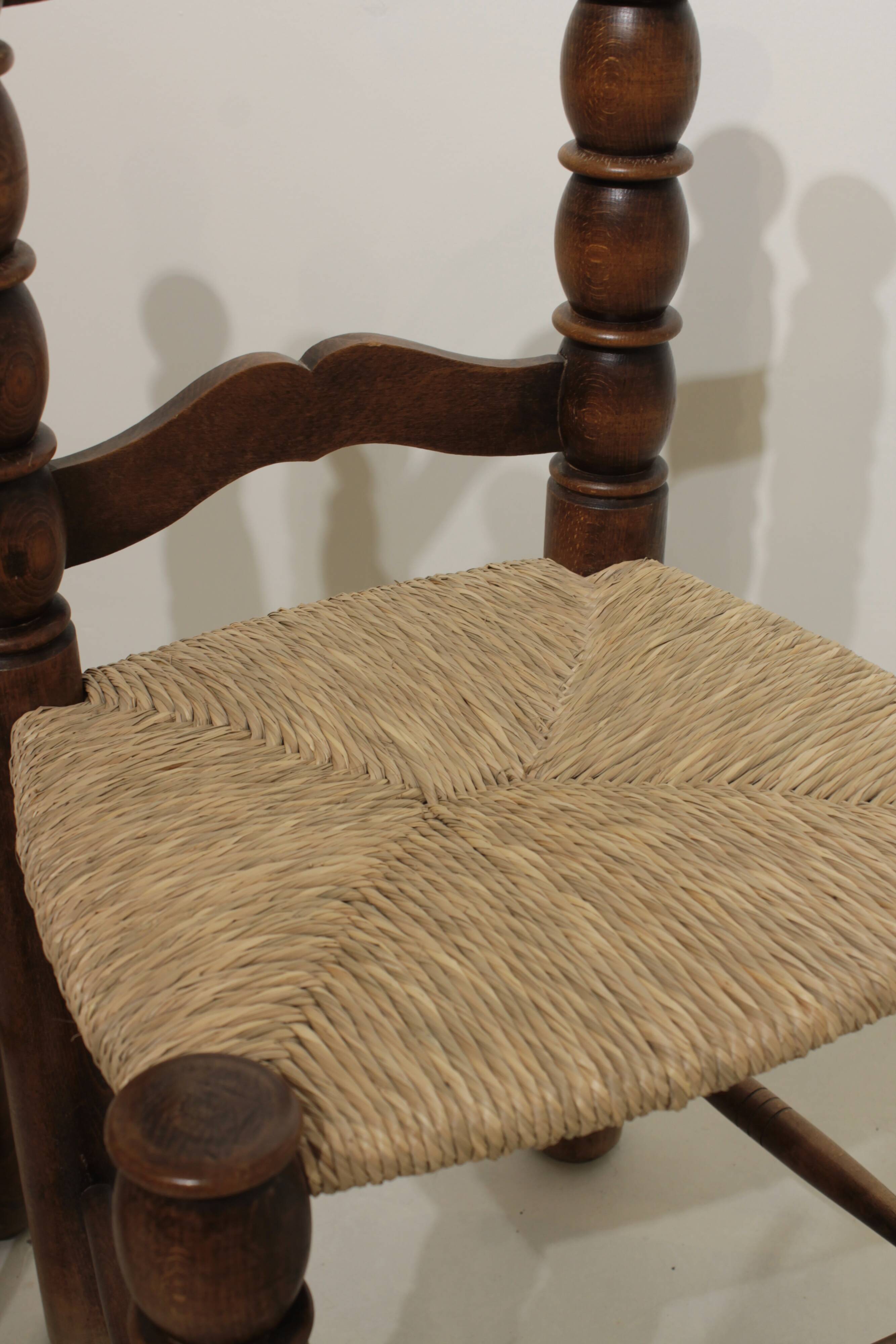 Pair of rustic chairs in turned wood with straw seats