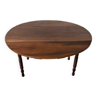 Oval walnut table with flaps