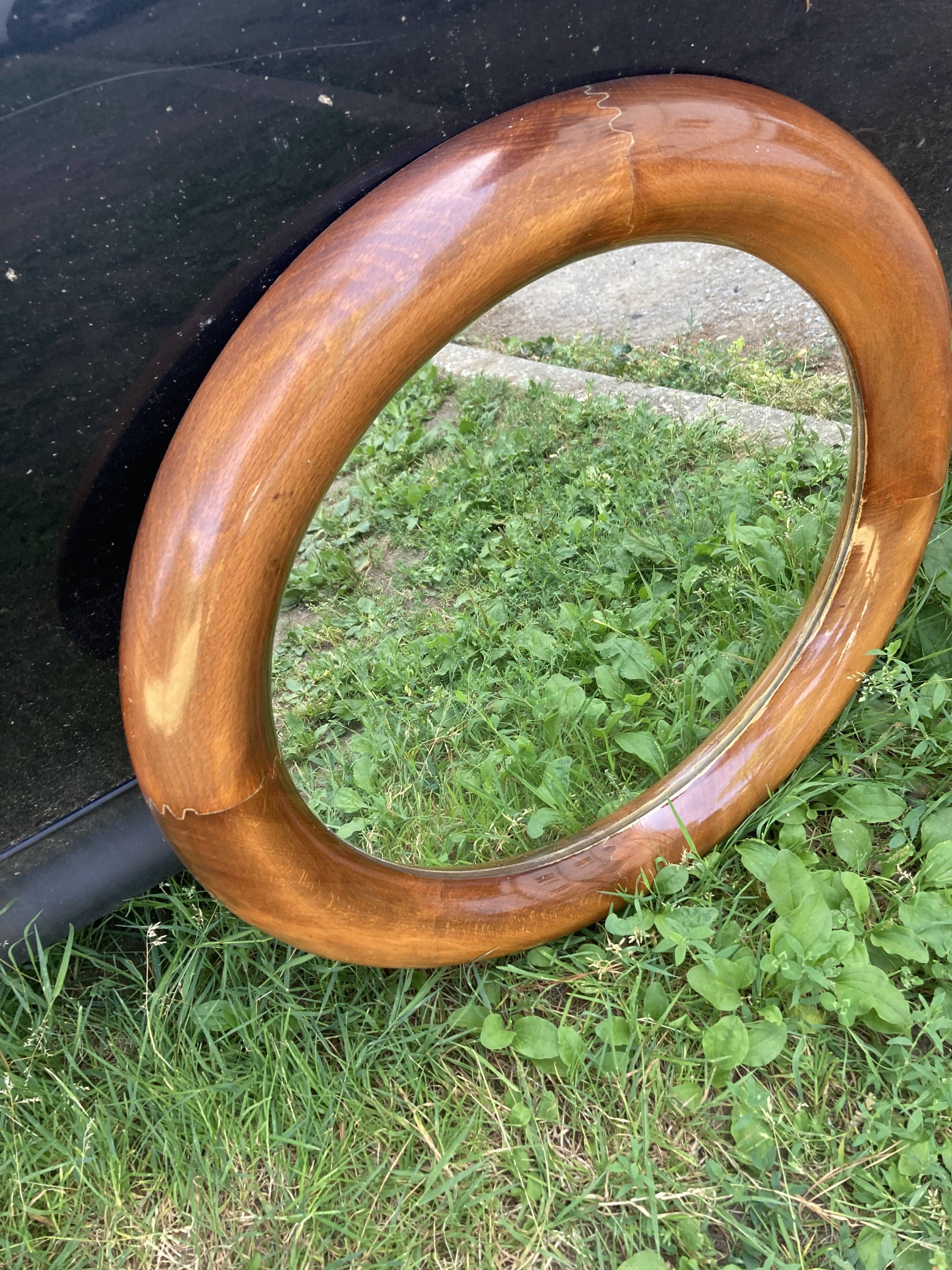 Round varnished wooden mirror