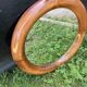 Round varnished wooden mirror