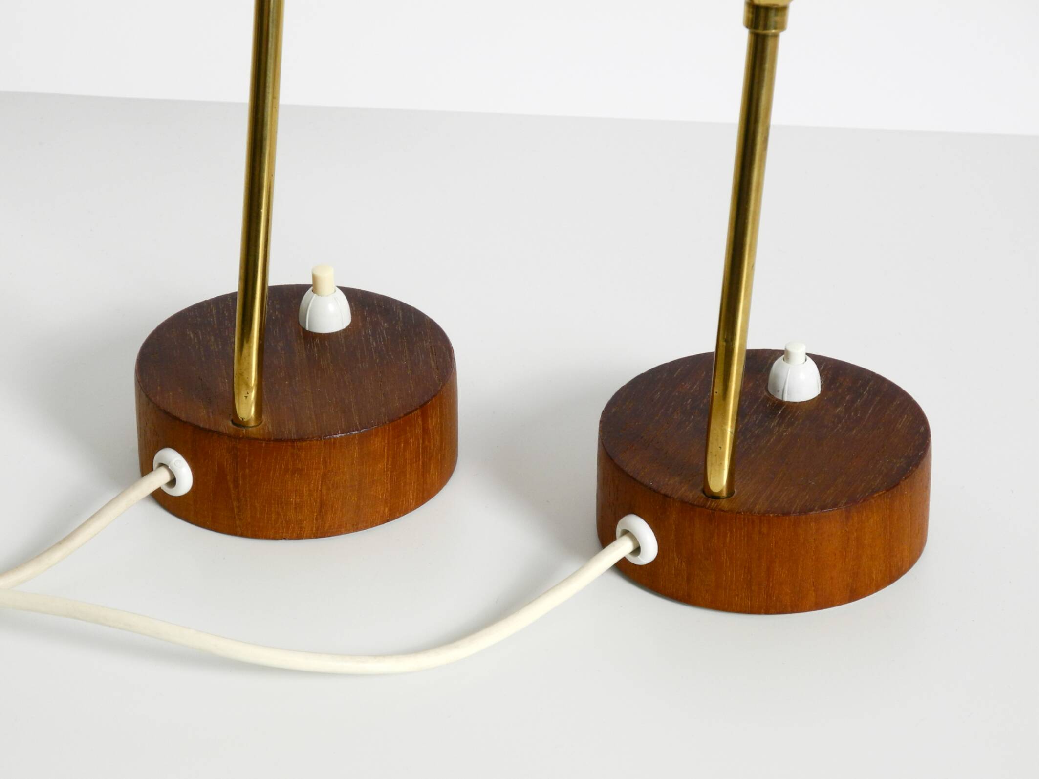 A pair of mid-century modern bedside lamps with perforated metal shades