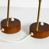 A pair of mid-century modern bedside lamps with perforated metal shades