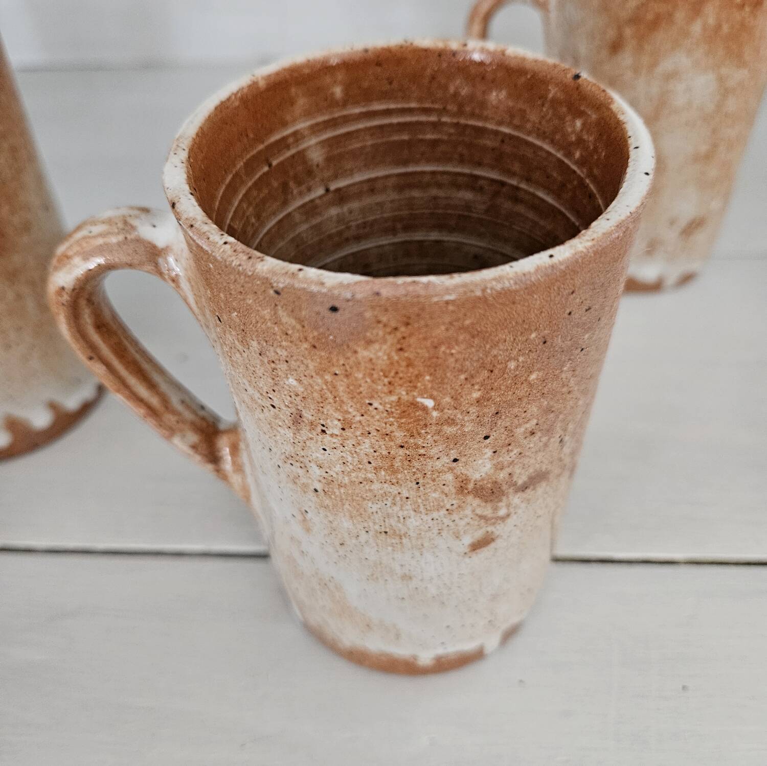 Set of 5 vintage handcrafted stoneware mugs in beige, pink, and white glazed stoneware