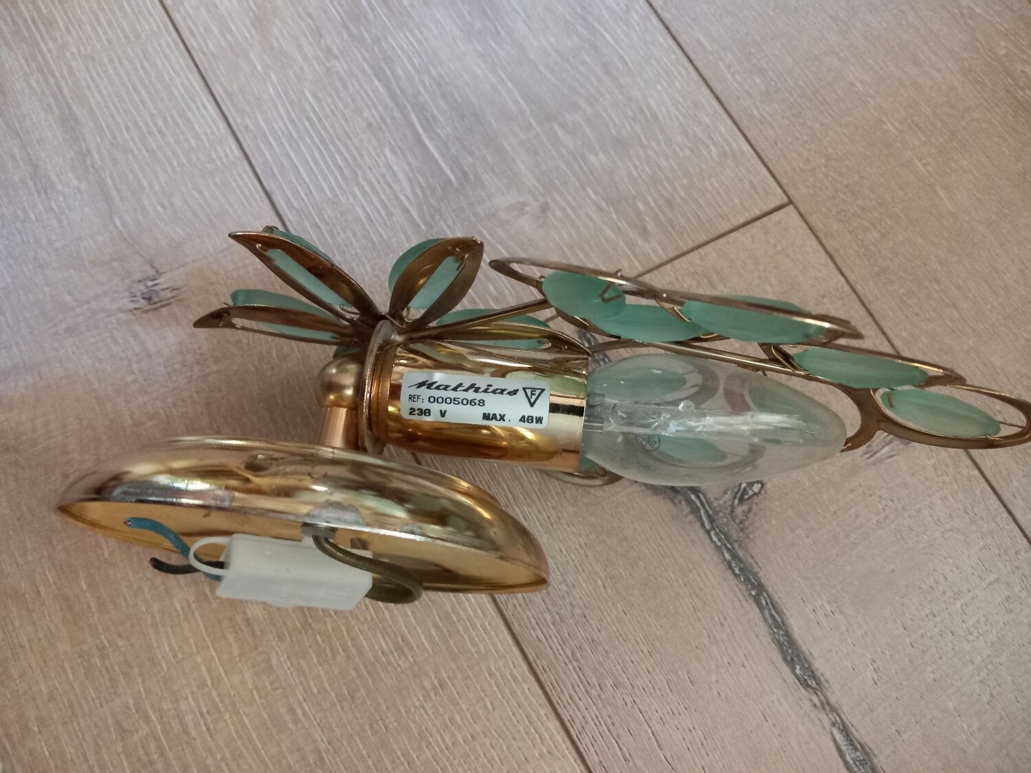 Gold metal wall light with light blue tassels