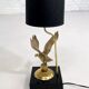 Brass lamp on black lacquered wooden base