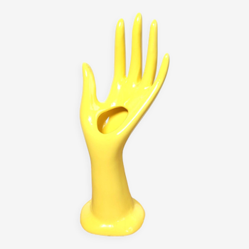 Hand wears ring and yellow soliflore