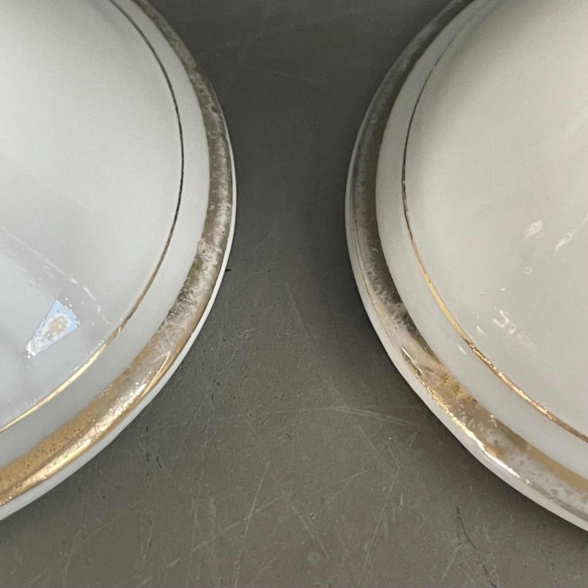 Pair of porcelain candlesticks with a gold pattern.