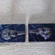 Pair of Art Deco bookends signed Frécourt, patinated metal & black marble