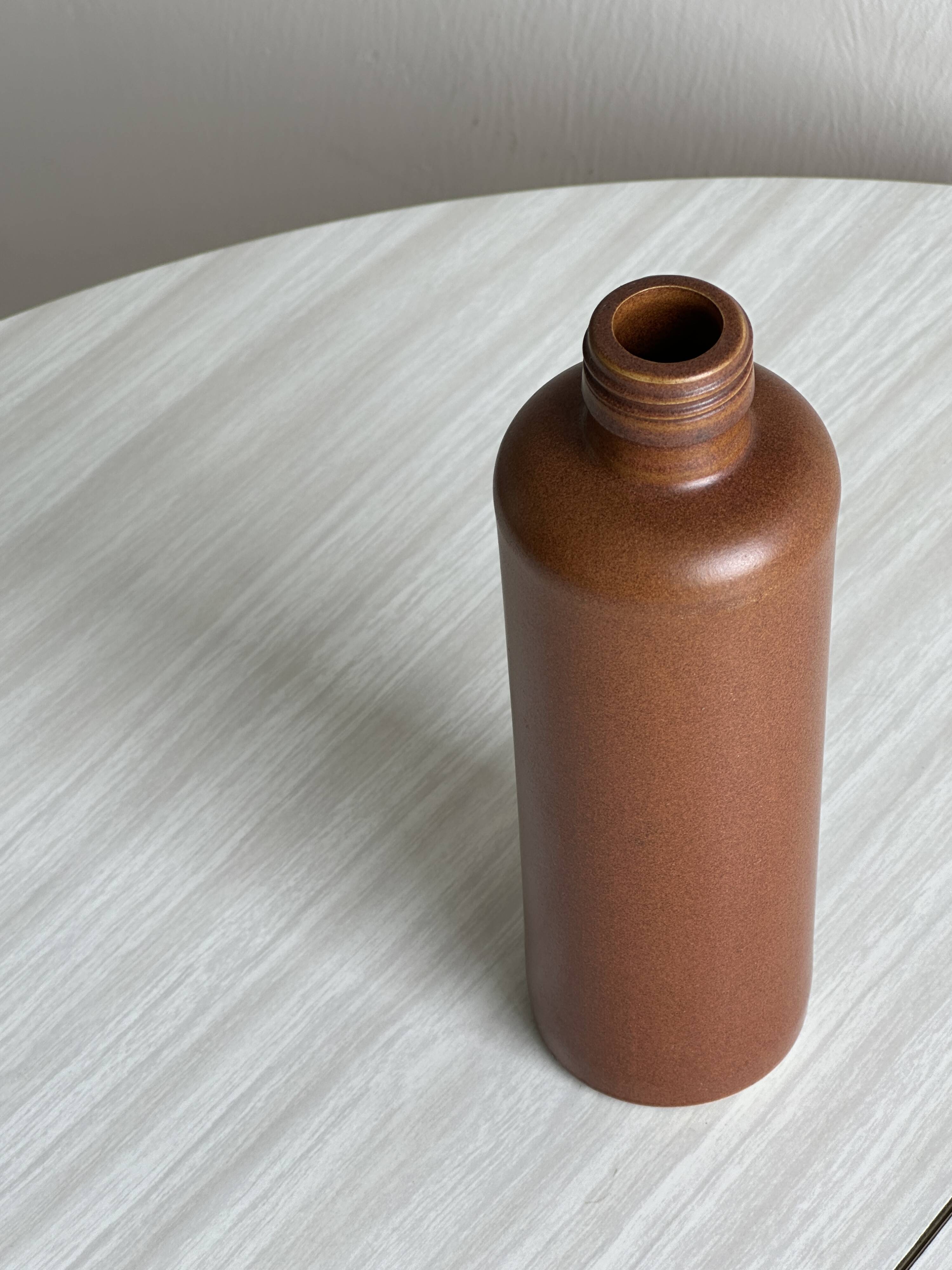 Decorative brown ceramic bottle.