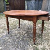 Louis Philippe oval shuttered table in solid cherry wood with 2 drawers.