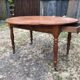 Louis Philippe oval drop-leaf table in solid cherry wood with 2 drawers.