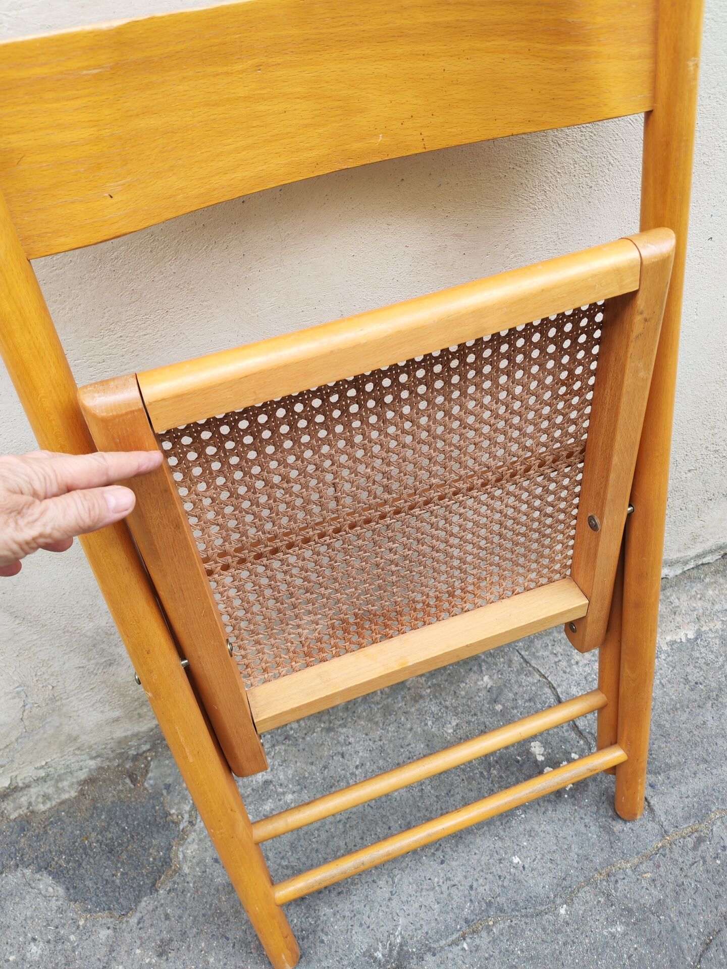 Wooden folding chair with caning from the 1980s.