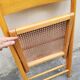 Wooden folding chair with caning from the 1980s.
