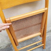 Wooden folding chair with cane from the 1980s.