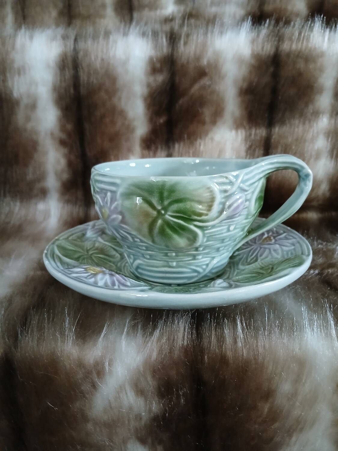 Antique cup and saucer in majolica.