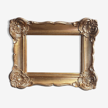 Old gilded frame in carved wood