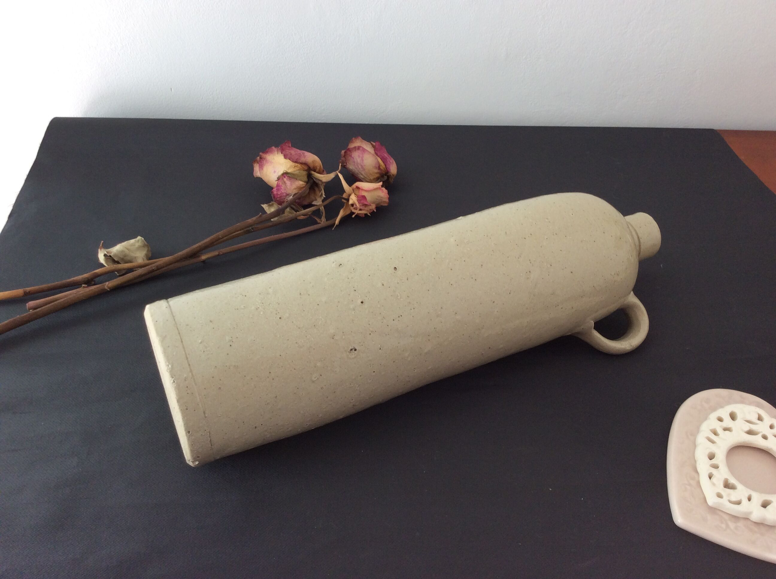 Old stoneware bottle with ear, loop