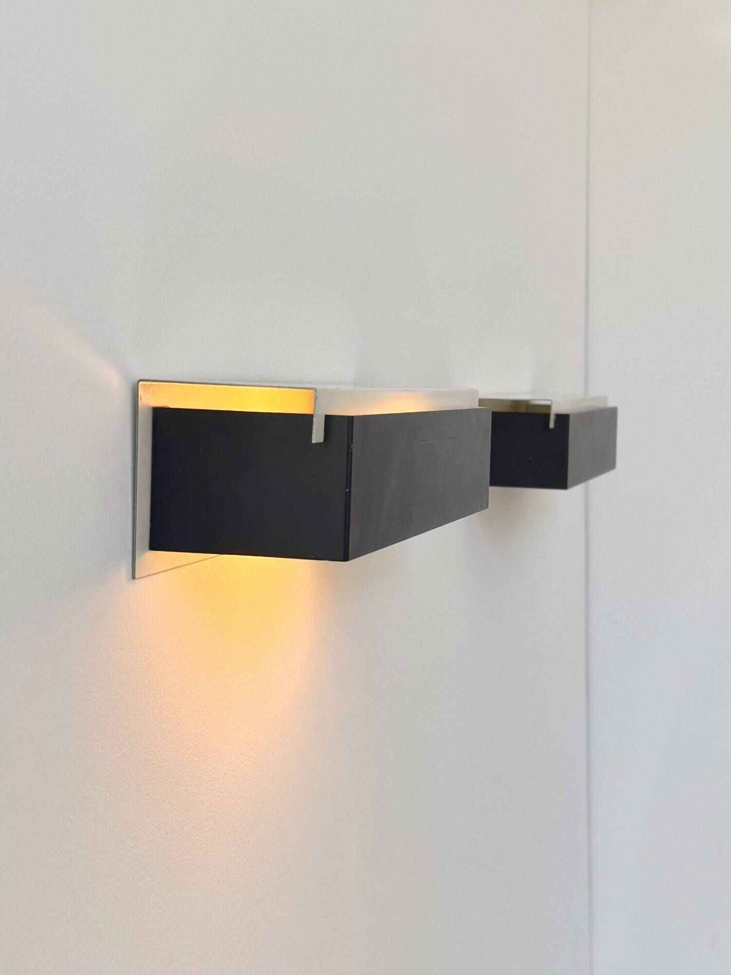 Pair of vintage wall sconces, painted black and white metal, Sweden 1970.