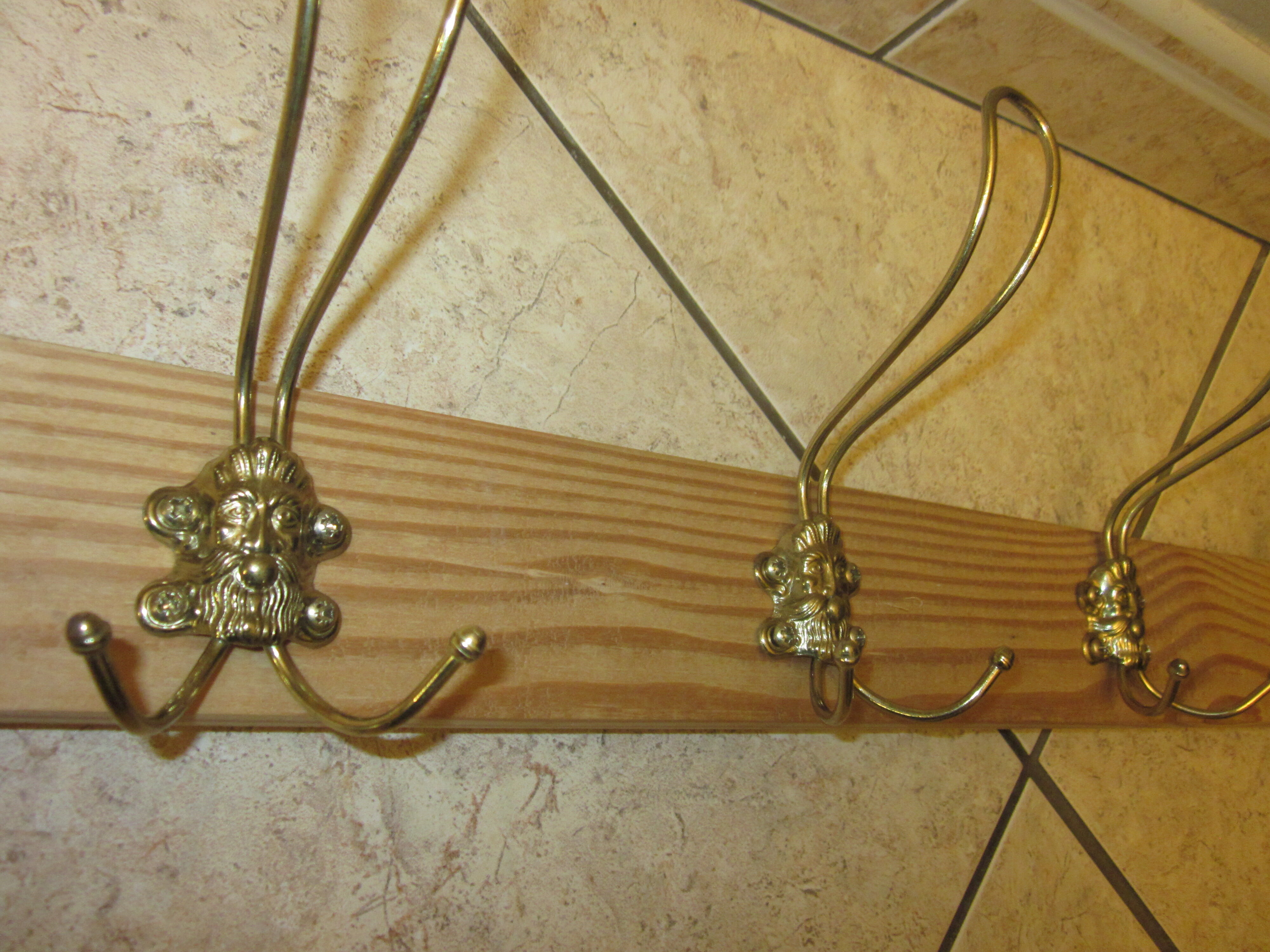 old coat rack with 5 metal hooks