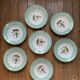 Set of 7 deep plates, turquoise rim and bird pattern.