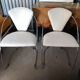 Set of two design chairs in steel and faux leather.