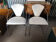 Set of two design chairs in steel and faux leather.