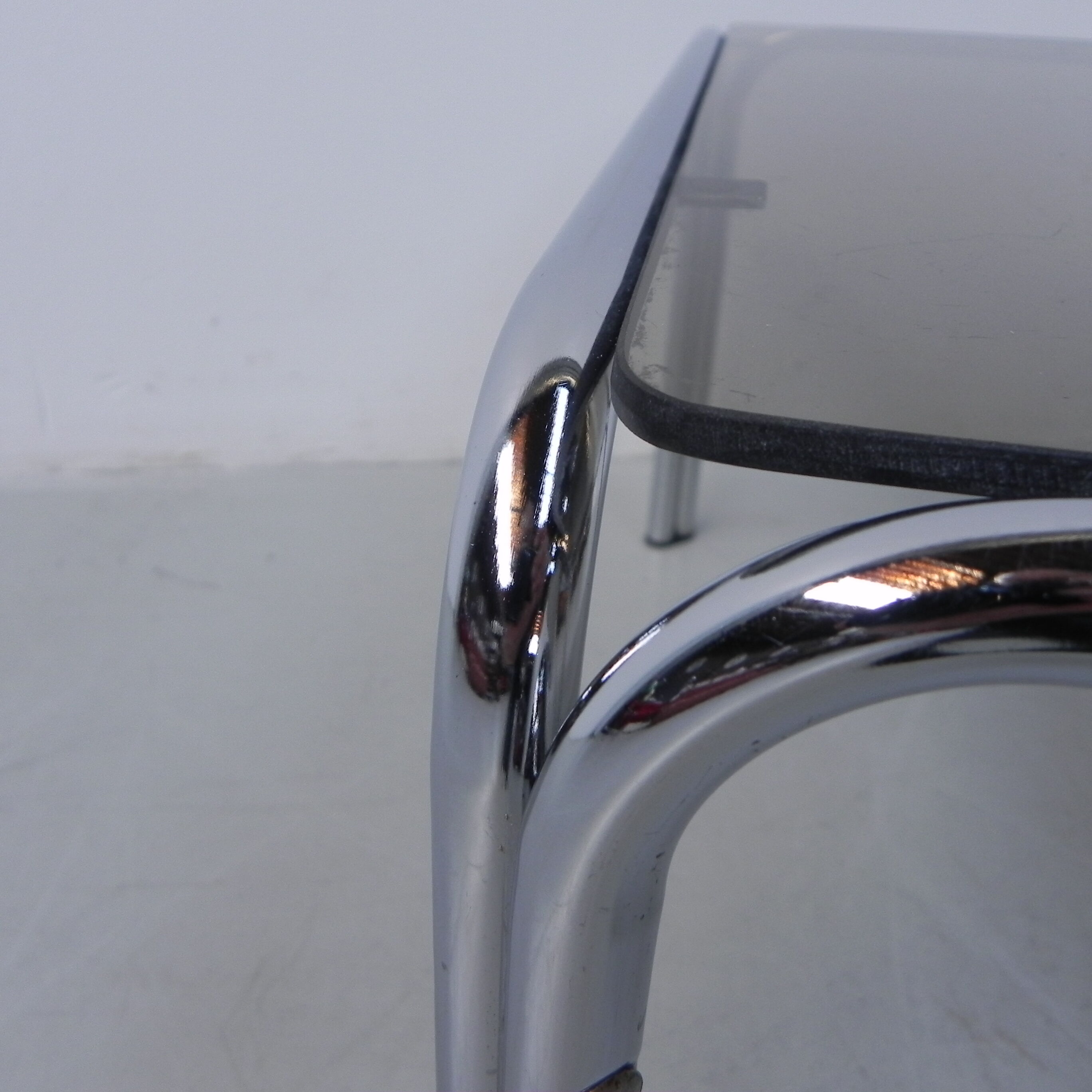 Coffee table with smoked glass top in chromed frame