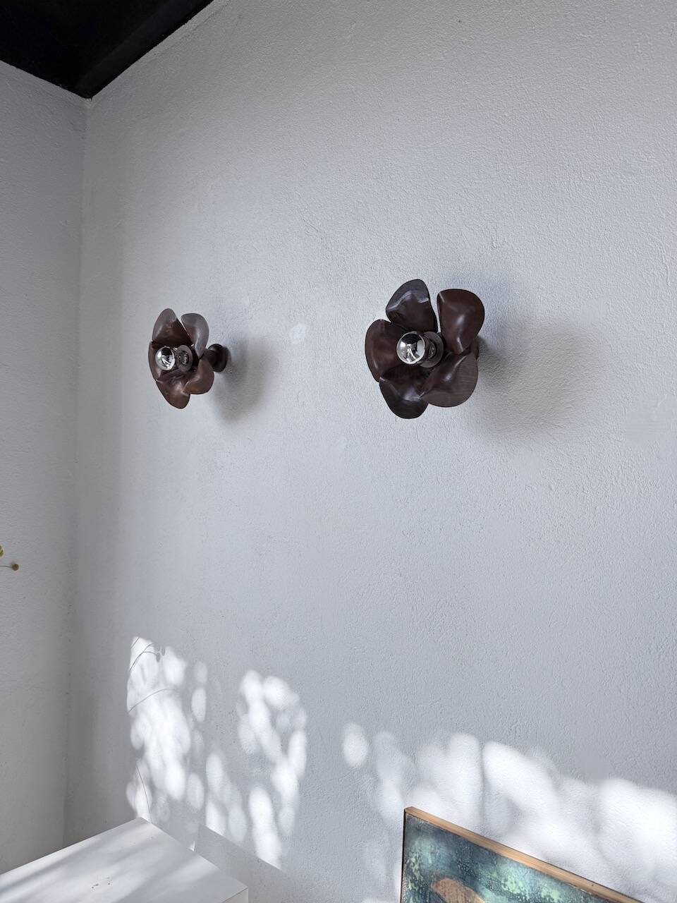 Four wooden flower wall lights from the 1970s.