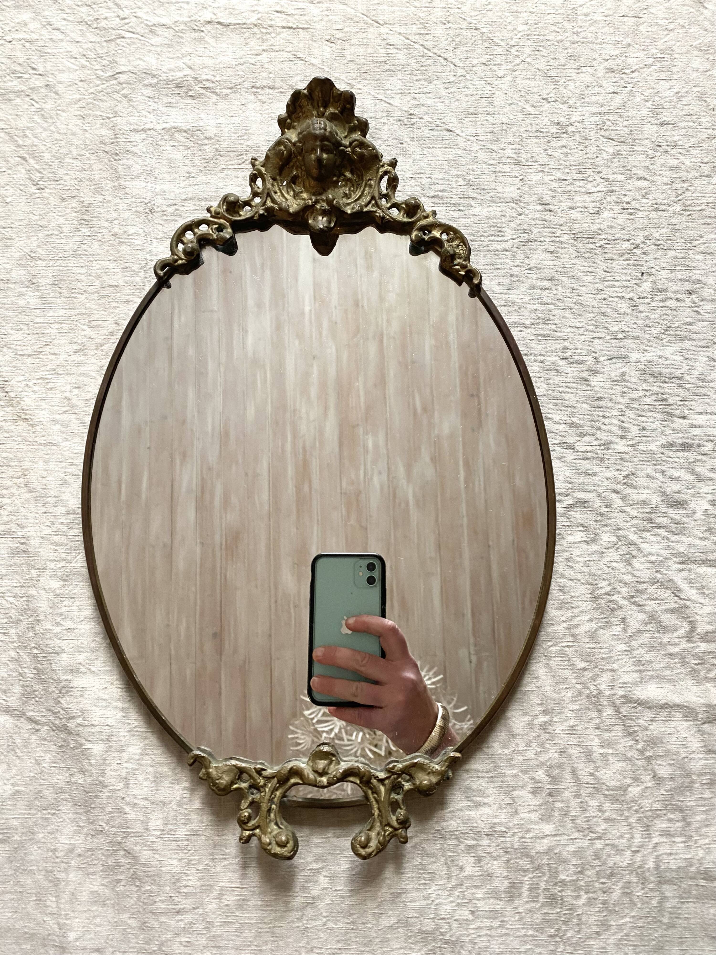 Antique oval brass crest mirror, 41x26 cm
