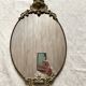 Antique oval brass crest mirror, 41x26 cm