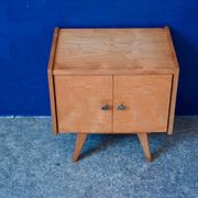 Rockabilly design bedside table with tapered legs.