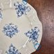 Old Gien plate with carved edges featuring doves and blue flowers, circa 1920-1930.